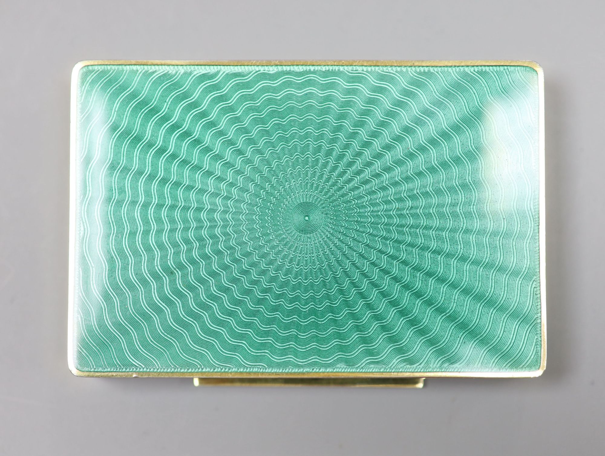 A cased early 20th century Austrian? gilt sterling and green enamelled silver gilt rectangular snuff box, 80mm, gross 122 grams,